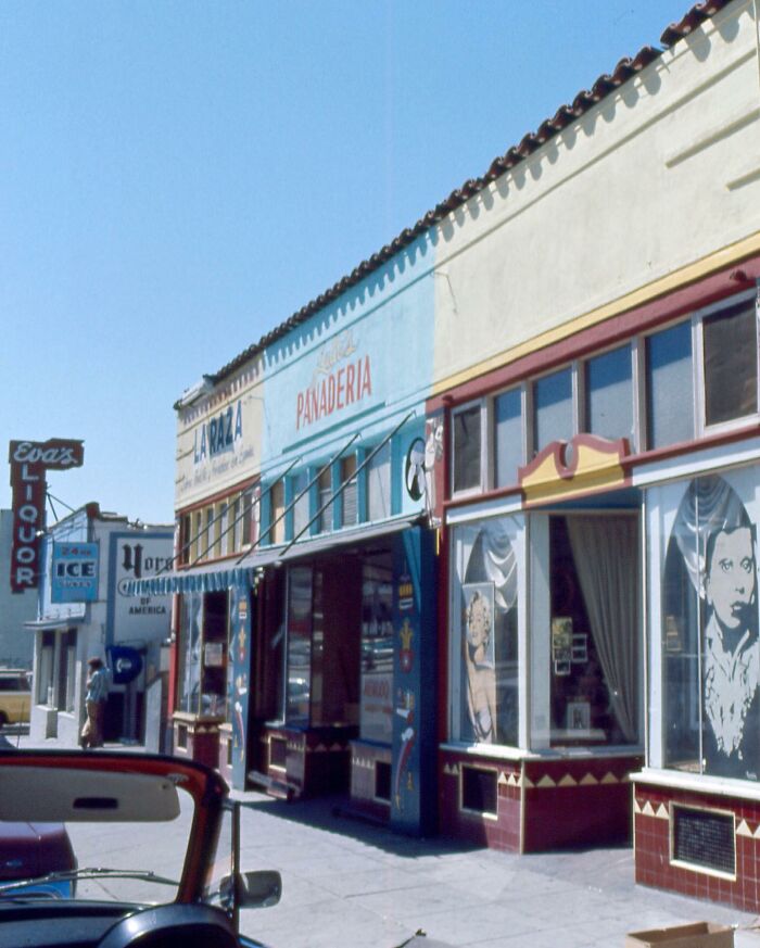1970s West Coast street with vintage shops and signage, capturing the iconic era's vibe with colorful storefronts.