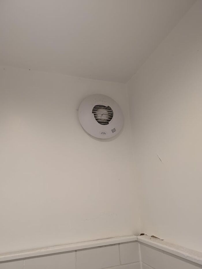 Wall-mounted smoke detector showcasing frugal home hacks for safety without spending a fortune.