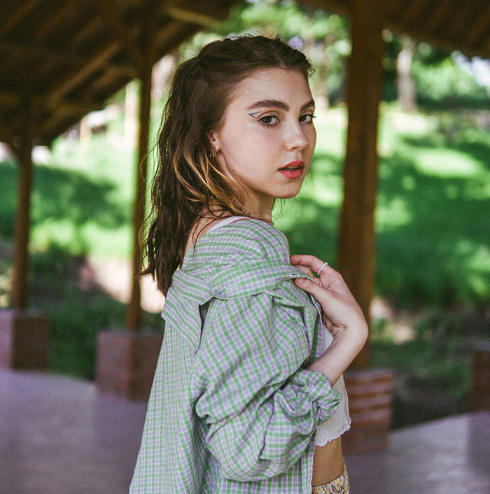 Young woman outdoors with shoulder slightly exposed, representing one of the unattractive things people wish others would avoid.