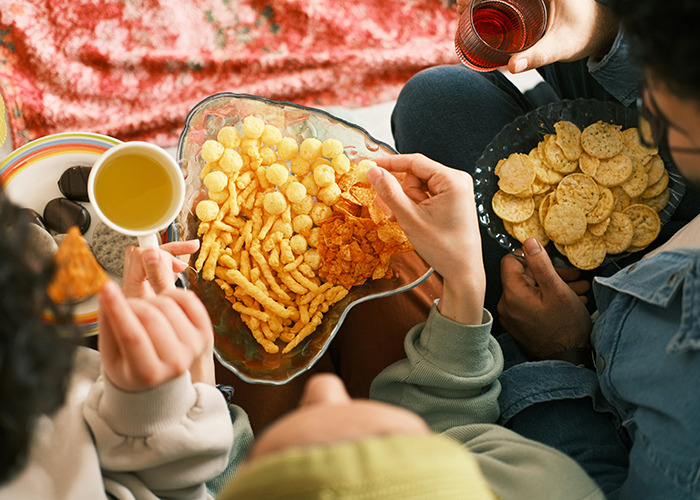 People enjoying a variety of snacks and drinks, showcasing health hacks for better living.