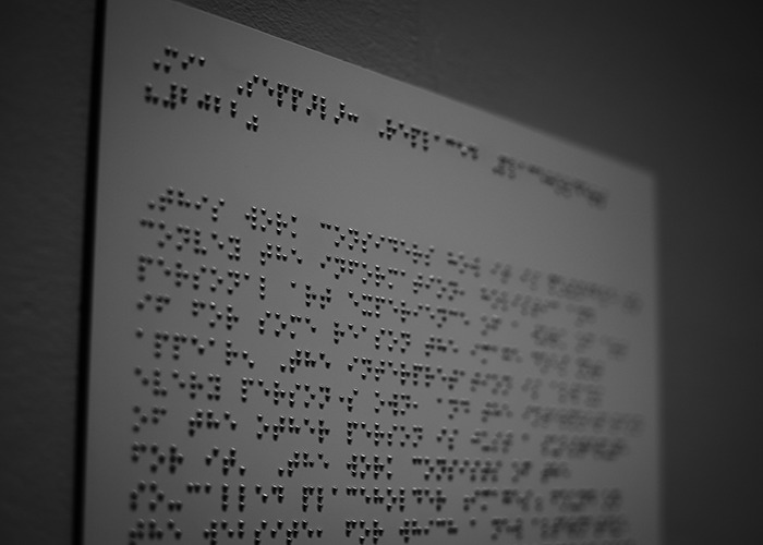 Braille text on a wall, highlighting health hacks importance.