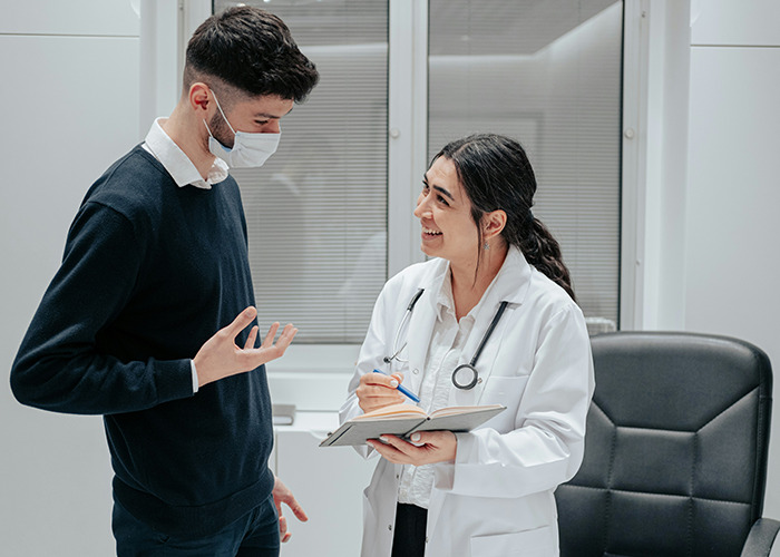 Doctor discussing health hacks with a man in an office setting.
