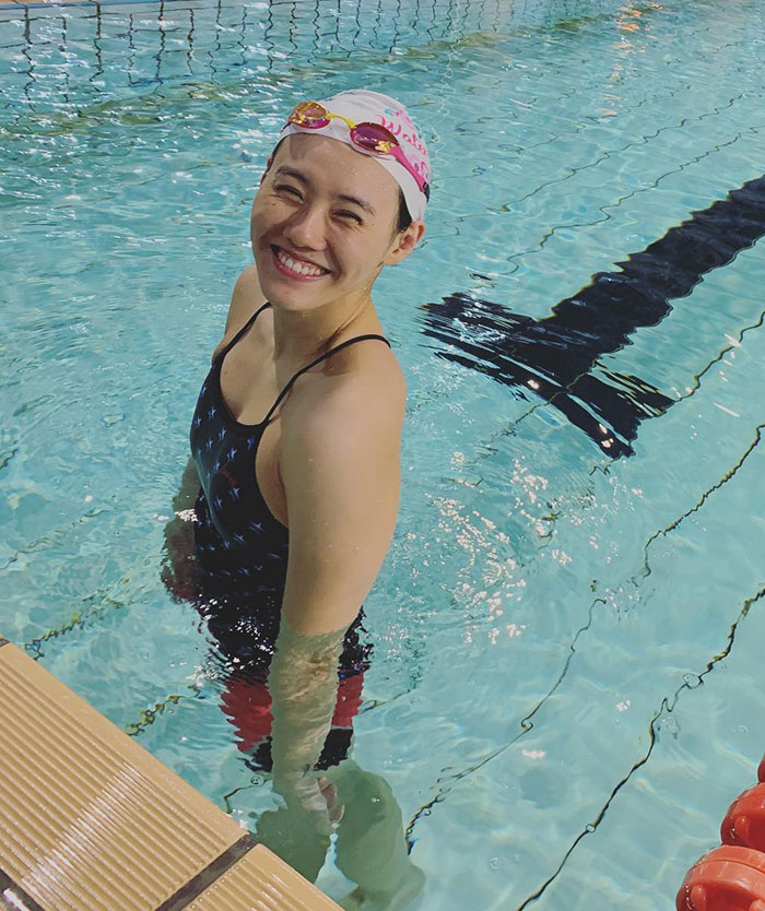 Smiling former Chinese athlete Liu Xiang in a swimsuit, standing in a pool. Smiling former Chinese athlete Liu Xiang in a swimsuit, standing in a pool.