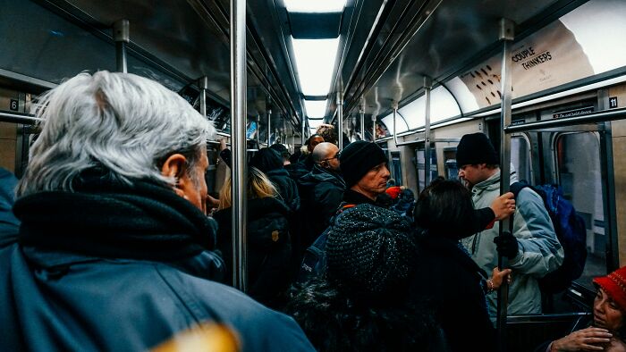 Passengers experience coincidences on a crowded subway train.