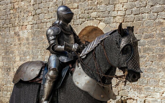 Knight in armor on horseback next to a stone wall, showcasing Pinterest's 2025 predictions.