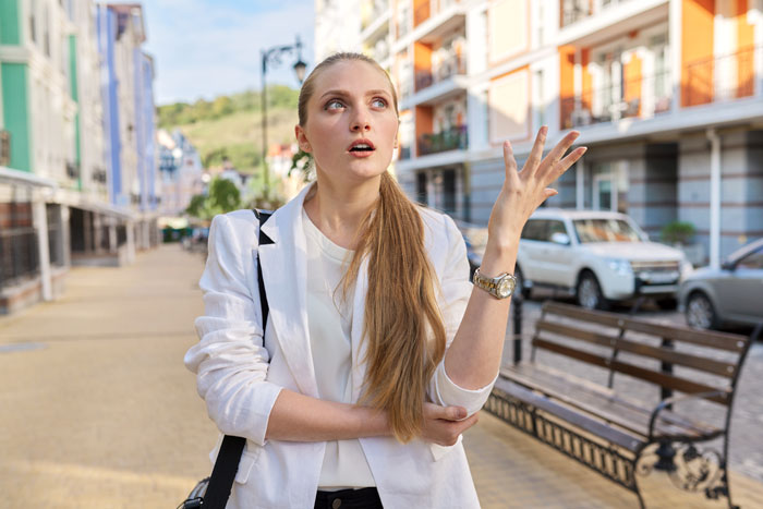 A woman looking frustrated, expressing distress