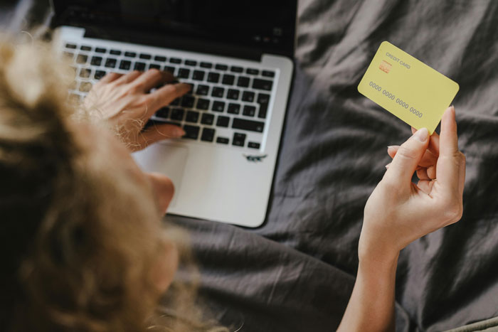 Mother handling money for family emergency on laptop. Mother handling money for family emergency on laptop.