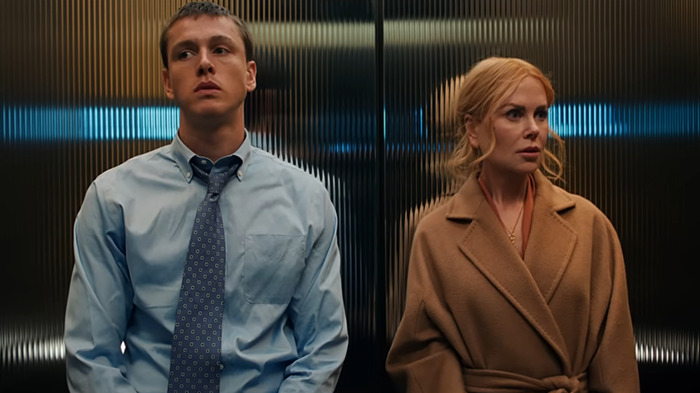 Nicole Kidman and co-star Harris Dickinson in an elevator scene from movie 'Babygirl', one in a suit and the other wearing a coat.