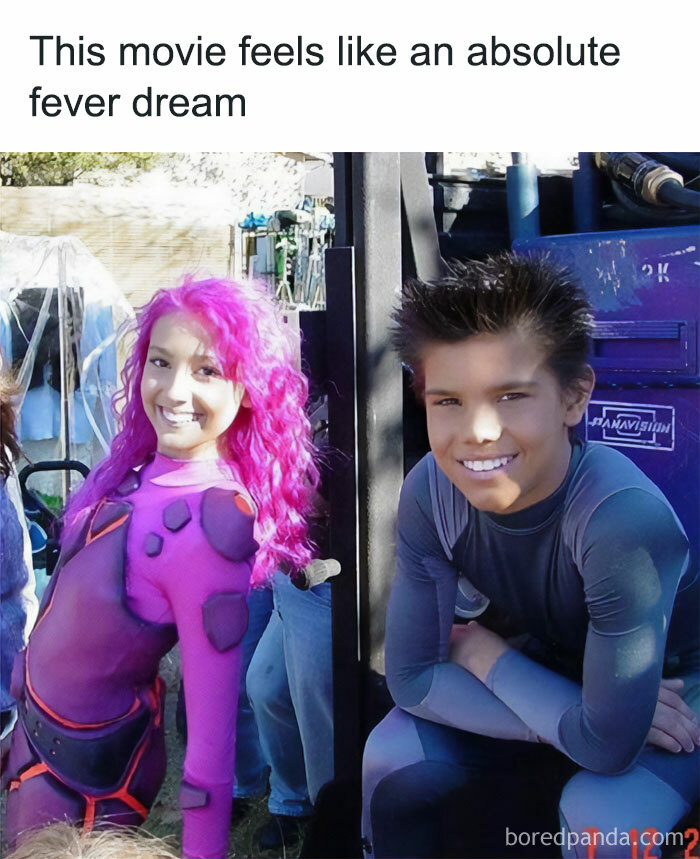 Two actors in vibrant costumes from nostalgic childhood shows on set, smiling at the camera.