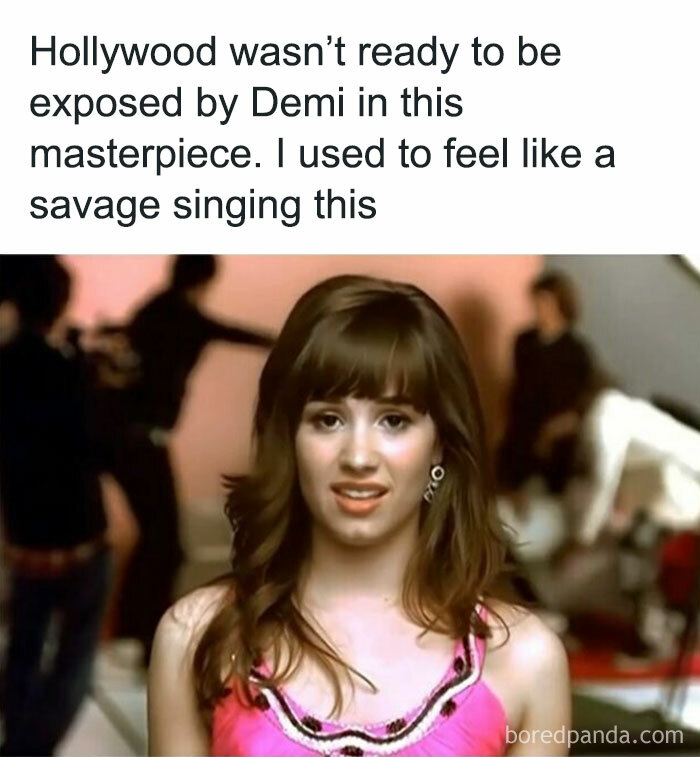 Young woman in a pink top from a nostalgic childhood show scene, with a blurred background.