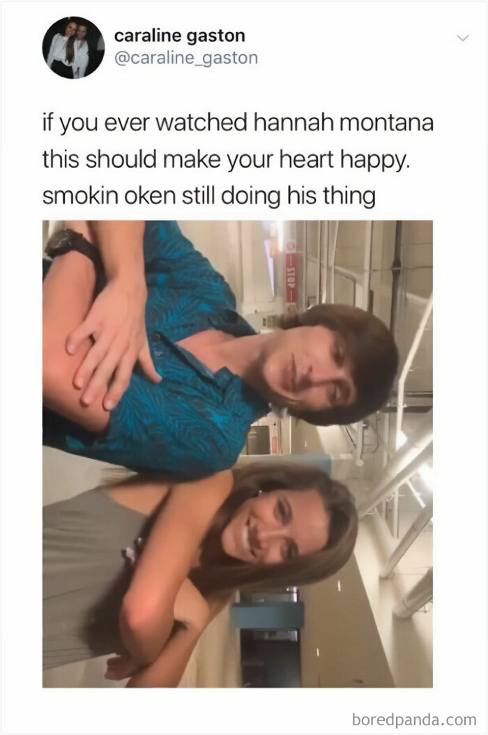 Two people smiling in a hallway, capturing a moment from nostalgic childhood shows.