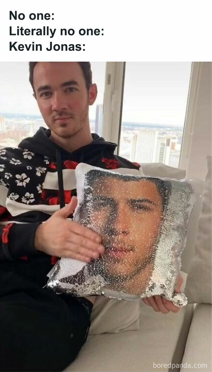 Person holding a sequin pillow with a face print, referencing nostalgic childhood shows posts.