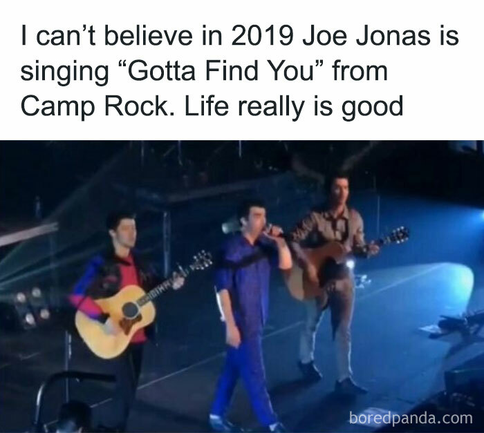 Nostalgic childhood shows moment with three people singing on stage, holding guitars, under concert lights.