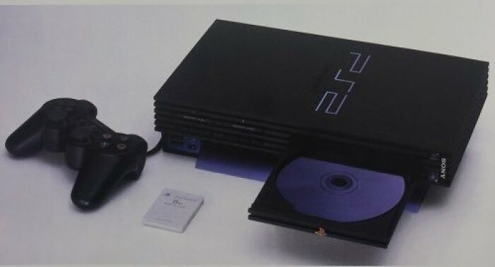 Old-Internet-Feel-Pics: Vintage gaming console, controller, and memory card setup.