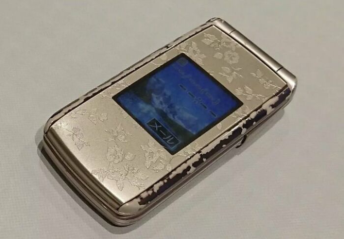 Flip phone with floral design, evoking an old-internet feel.