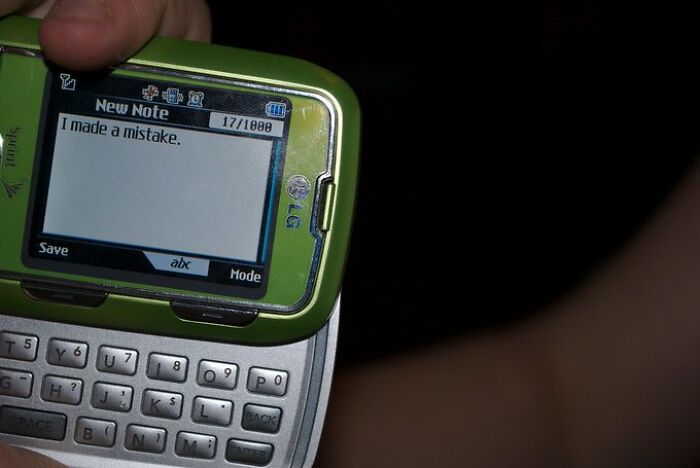 A green slide phone displaying "I made a mistake," capturing an old internet feel.