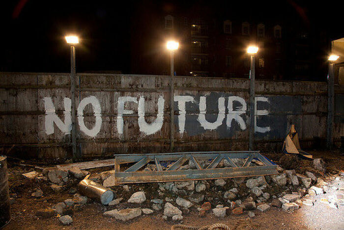 Graffiti on a wall at night saying "NO FUTURE," evoking an old internet feel in the urban setting.