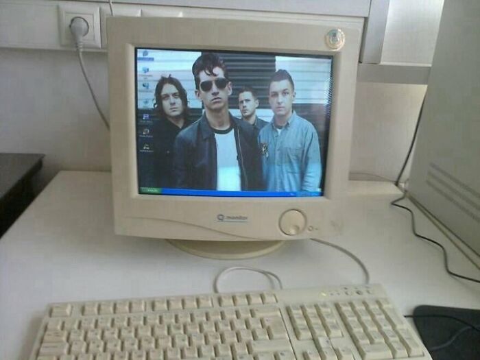 Old-style CRT monitor displaying a band photo, highlighting the old-internet feel.