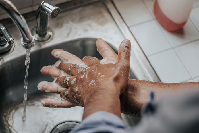 Hands washing with soap under running water, highlighting cleanliness and hygiene, related to Hollywood secrets.
