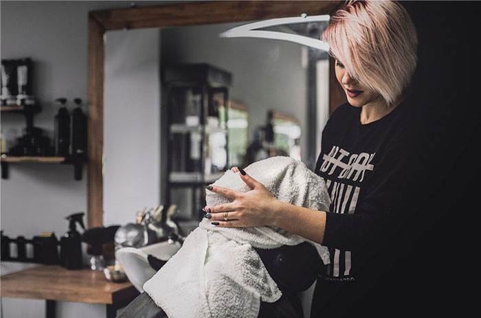Stylist wraps client's head in towel in salon, sharing Hollywood secrets.
