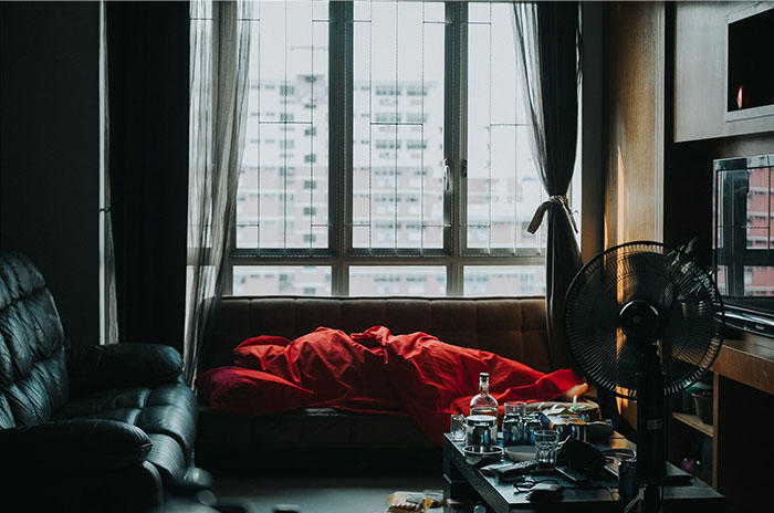 A cozy living room with a red blanket, soft lighting, and a city view, capturing a secretive Hollywood ambiance.