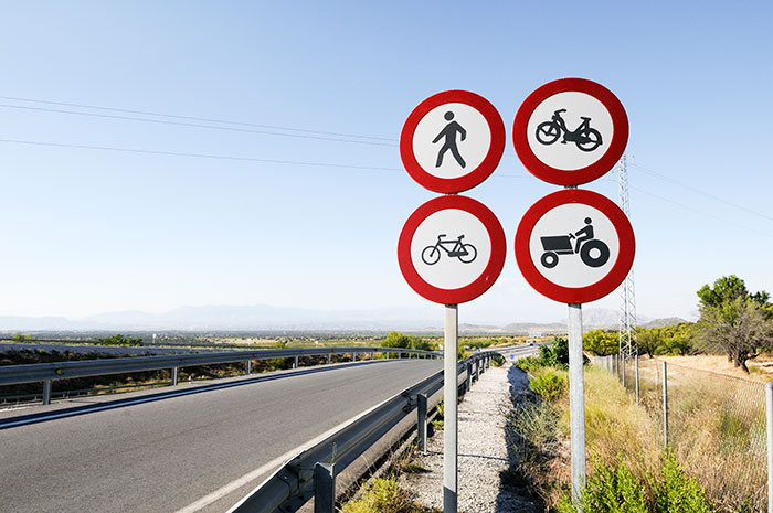 Road signs with various prohibitions on a sunny day, symbolizing low-effort tasks.
