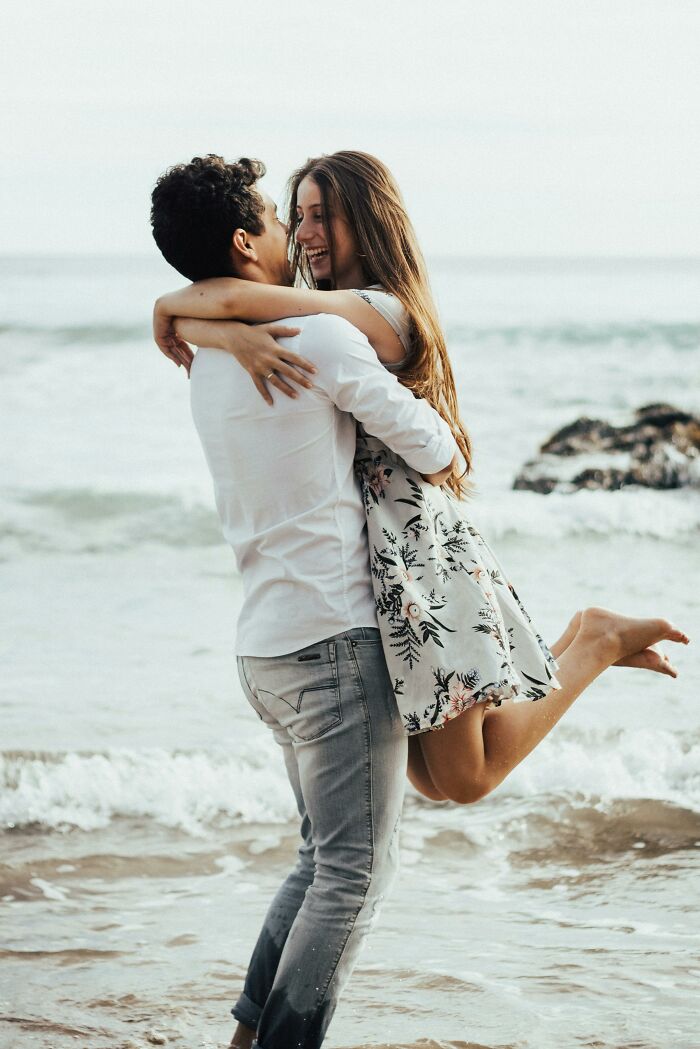 A couple embracing on a beach, representing best friends turned strangers.