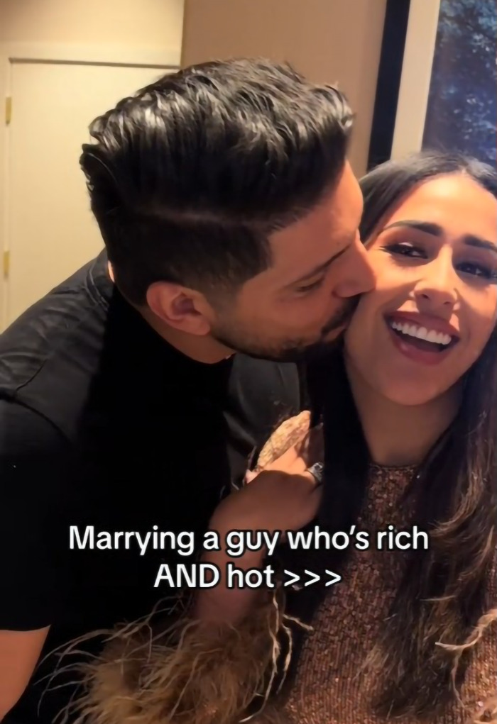 Dubai housewife with partner, criticized for materialism amidst Christmas gift display.