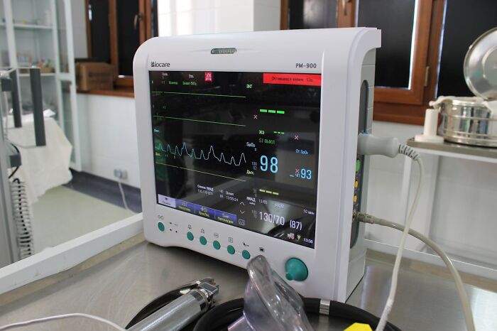 Medical equipment in a hospital setting, displaying heart rate and vital signs.