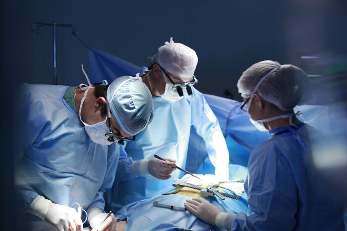 Medical professionals performing surgery while debunking health myths in a sterile operating room.
