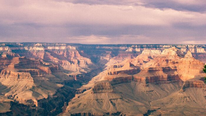 Grand Canyon landscape at sunset, showcasing unusual rock formations and vibrant colors.