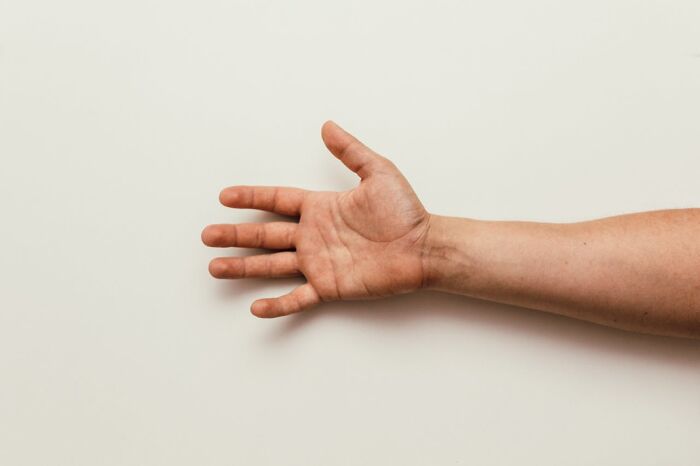 An outstretched hand against a plain background, illustrating really messed up moments.