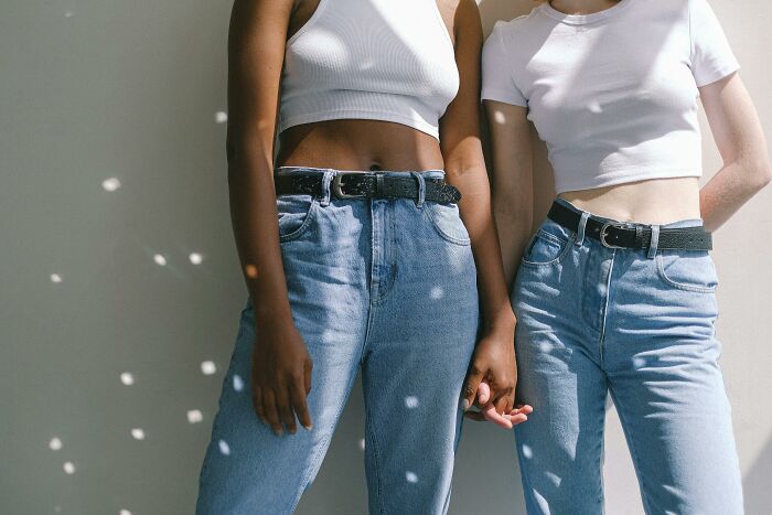 Two people in trendy denim and white tops, embodying Pinterest's 2025 fashion predictions.