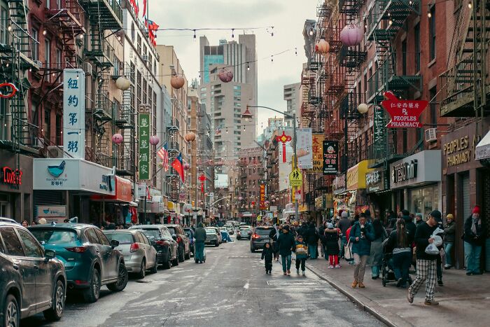 A bustling city street scene with people walking.