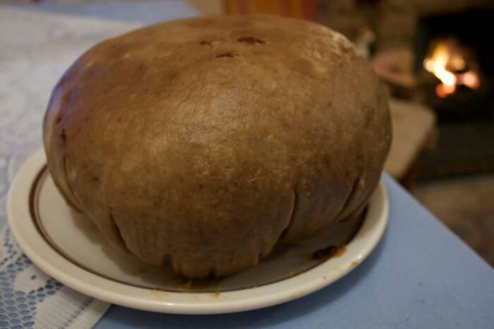 Traditional Scottish haggis on a plate, capturing the essence of Scottish cuisine by a warm fireplace.