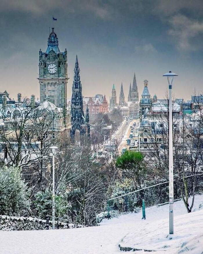 Snow-covered Edinburgh cityscape showcasing iconic Scottish architecture.
