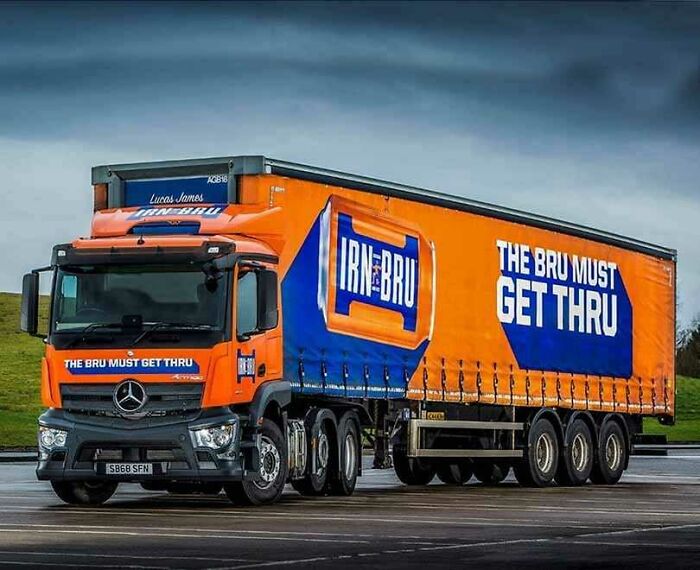 Irn-Bru truck with "The Bru Must Get Thru" slogan, showcasing Scotland's humor and culture on a vibrant blue and orange design.