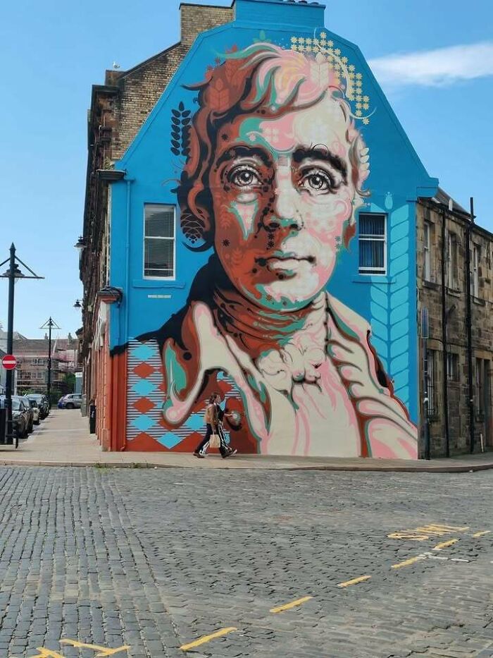 Colorful mural of a historic figure on a Scottish building, capturing Scotland's vibrant street art and culture.