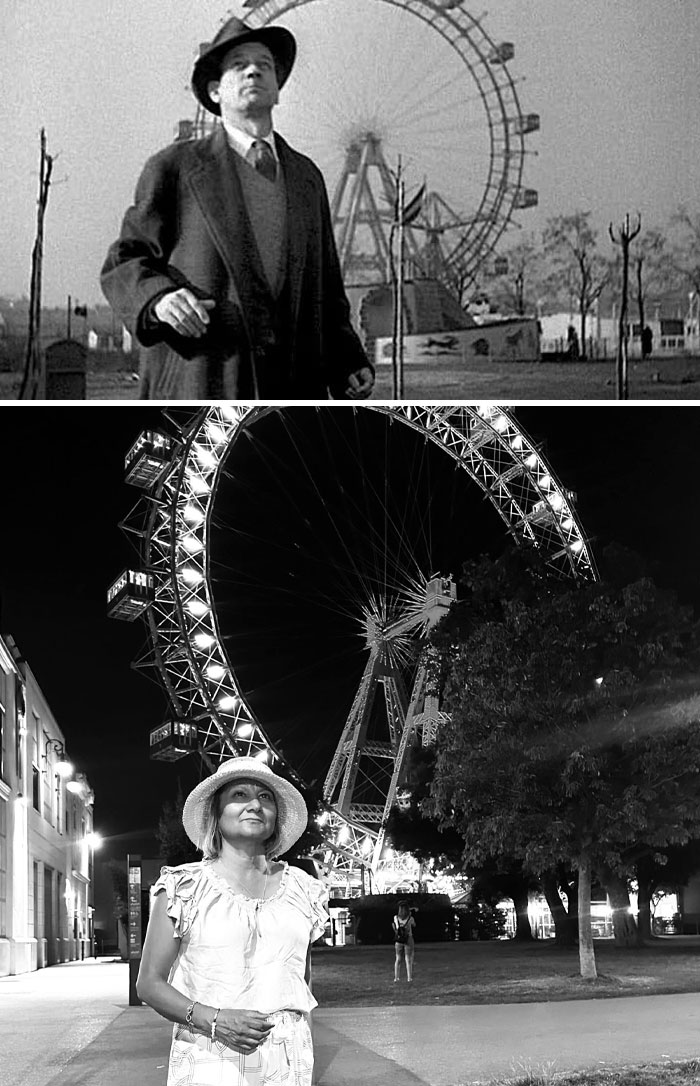 Famous movie location with a Ferris wheel in the background, featuring a man in a suit and a woman in a hat.