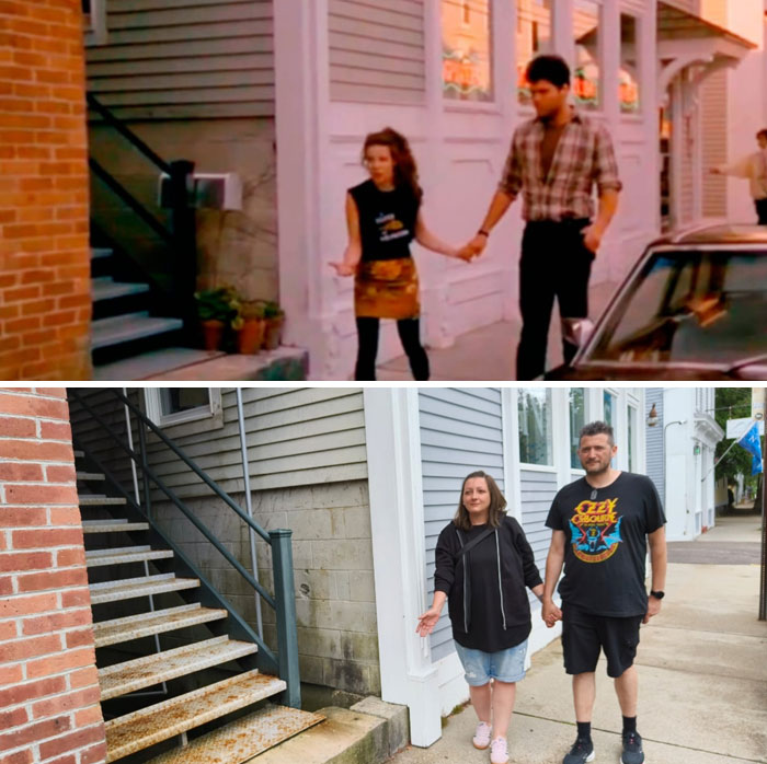 Couple reenacting a famous movie scene at a popular film location beside a building with stairs.