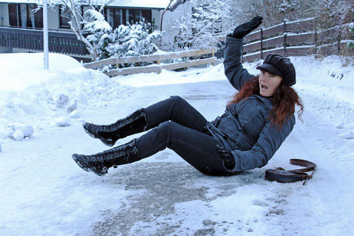 Person slipping on icy sidewalk, illustrating frustration when neighbors don't shovel snow.