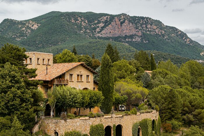 Beautiful villa surrounded by lush greenery, a perfect retirement gift setting with scenic mountain views.