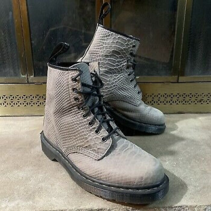 Stylish retirement gift: snakeskin-patterned leather boots on display.