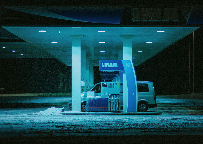 Van at a dimly lit gas station at night, highlighting the weirdest driving experiences theme.