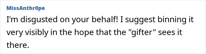 Text comment expressing frustration about a Secret Santa gift, suggesting discarding it visibly.