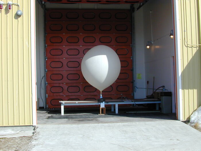 Large balloon in an open hangar, illustrating one of the strangest delivery stories.