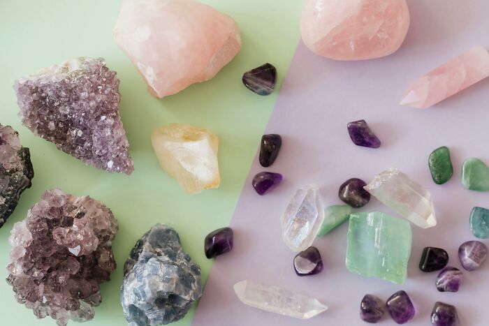 Colorful gemstones and crystals on a pastel background.