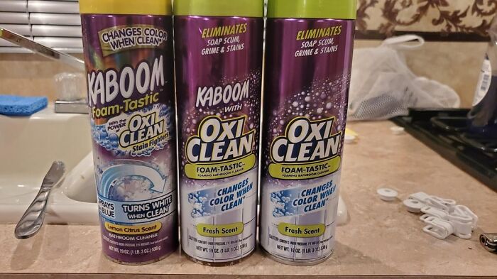 Three cans of Kaboom Foam-Tastic cleaner on a kitchen counter, related to strangest delivery stories.