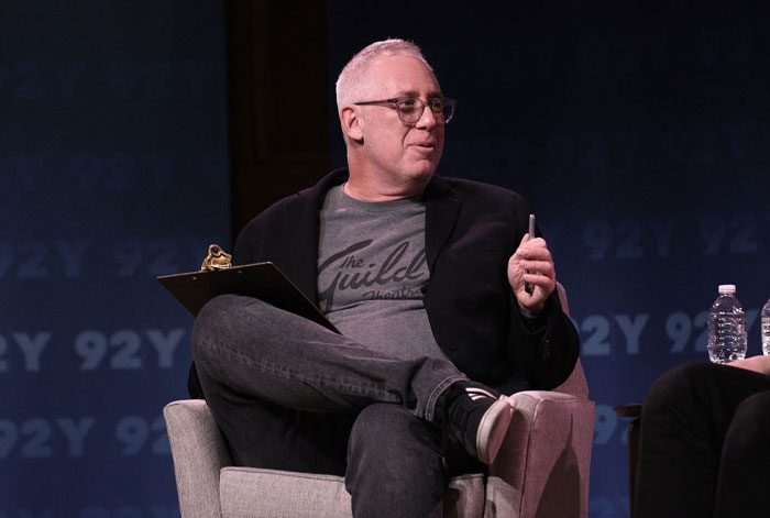 Brian Koppelman in a casual setting, holding a pen and clipboard, discussing "The Bear" cast's guest appearances and returning stars.