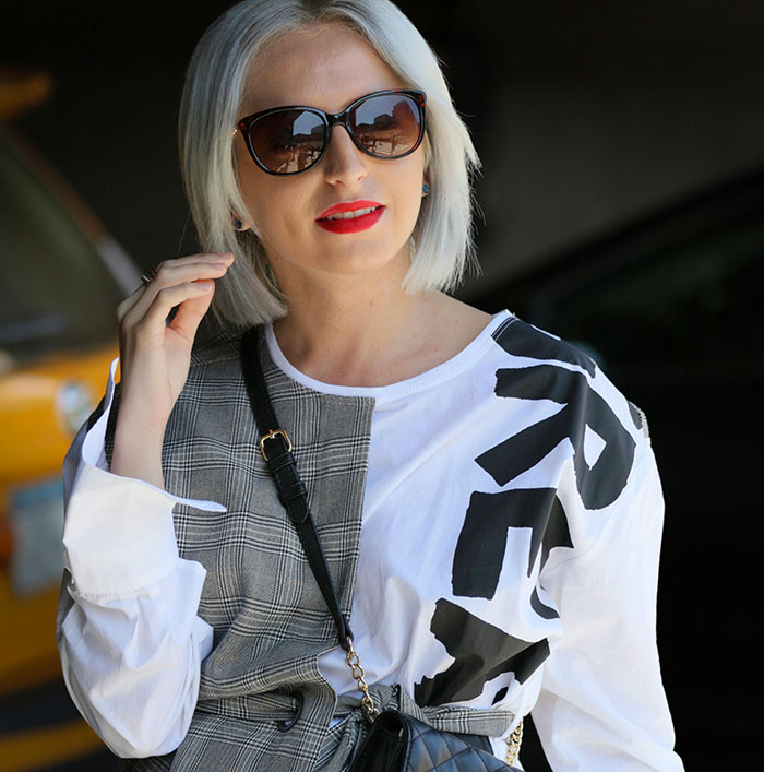 Woman with sunglasses and a stylish outfit posing, illustrating unique rare statistics.